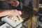 Production process of ravioli, tortellini and cappelletti, typical fresh Italian pasta - the hands of the chef flour the ravioli