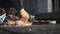 Production worker. A man cuts a sheet of metal with a grinder