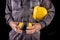 A production worker in workwear with a helmet and hearing protectors in hand. Special workwear for employees