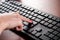 Productivity in Action: Young Female Typing on Black Computer Keyboard