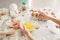Products for baking. Kid\'s hands cook sweets. Flour with dough, eggs, eggshells, and biscuits on the kitchen table.