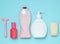 Products for the care of body, hair and personal hygiene on a blue pastel background. A bottle of fragrant perfume, lotion, shampo
