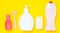 Products for the care of body, hair and personal hygiene on a yellow background. A bottle of fragrant perfume, lotion, shampoo