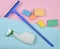 Products for cleaning glass windows. Sponges, window mop, sprinkler cleanser on a blue pink pastel background. Objects for home cl