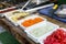 Products for cooking falafel in dishes on a wooden table. Street food ready to serve on a food stall.