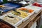 Products for cooking falafel in dishes on a wooden table. Street food ready to serve on a food stall.