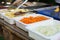 Products for cooking falafel in dishes on a wooden table. Street food ready to serve on a food stall.