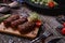 Products grill: steak, sausage and vegetable on a rustic wooden table. Sausages on the grill pan on the wooden background. Horizon