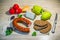 Products on the table â€“ smoked sausage, brown bread, cheese and vegetables