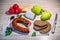 Products on the table â€“ smoked sausage, brown bread, cheese and vegetables