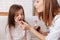 Professioanl caring nurse giving pills to little girl