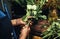 This profession require you to have a delicate touch. an unrecognizable florist arranging flowers inside her plant