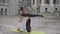 Professional acrobatic yoga. Fit caucasian couple practising plank bird pose balancing together performing acro exercises on mat o