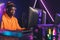 professional African American gamer focused on winning in online video games tournament medium closeup game battles neon
