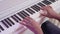 Professional african american musician playing on piano, hands close-up view.