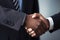 Professional agreement: A photo featuring the hands of two African American business individuals firmly clasped in a