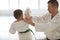 Professional aikido trainer teaching boy during the lesson