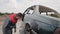 The professional air blasting worker checks his job on a repaired car after rust removing with sand blastig gun