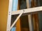 Professional aluminium ladder, wooden wall