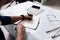 Professional architect makes notes in a notebook on a table with a drawing and ruler