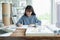 Professional architect women working in designer jobs while drafting on blueprint with modern house model on desk having material
