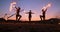 Professional artists show a fire show at a summer festival on the sand in slow motion. Fourth person acrobats from