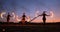 Professional artists show a fire show at a summer festival on the sand in slow motion. Fourth person acrobats from