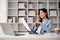 Professional Asian businesswoman reading and reviewing business reports at her desk