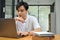 Professional Asian male employee worker concentrating on his project on laptop computer