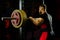 Professional athlete prepares to squat with a barbell