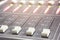 Professional audio mixing console with faders and adjusting knobs - radio