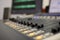 Professional audio mixing console with faders and adjustment knobs.