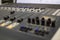 Professional audio mixing console with faders and adjustment knobs.