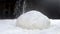 Professional Baker sprinkles white wheat flour on top of a ball of raw dough. Traditional bread Making in the kitchen. Close-up, s