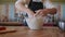 Professional baker working in bakery shop, kneading dough for bread, using traditional recipes. Lifestyle healthy eating