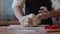 Professional baker working in bakery shop, kneading dough for bread, using traditional recipes. Lifestyle healthy eating