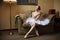 Professional ballet dancer sitting on sofa