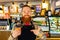 Professional barista young redhaired ginger bearded man in black apron working in coffee shop