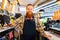 Professional barista young redhaired ginger bearded man in black apron working in coffee shop