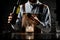 Professional bartender pouring a golden alcoholic drink from the steel jigger to a glass cup