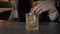 Professional bartender uses jigger glass for cocktail