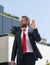 professional bearded ceo in suit gesturing stop. businessman in red tie.