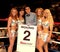 Professional Boxing referee with round card girls.