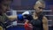 Professional boxing, sportsman fight with fists in boxing gloves while sparring in ring at contest close-up, slow motion