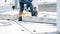 A professional builder cuts iron rebar with an angle grinder machine on a reinforced concrete slab at a construction site. Sparks