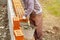 Professional builder laying bricks and building a house at a construction site. Detail of manual adjustment brick, bucket, trowel