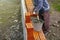 Professional builder laying bricks and building a house at a construction site. Detail of manual adjustment brick, bucket, trowel