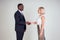 Professional business people handshaking in white background studio. African American man and Caucasian woman