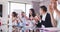 Professional businesspeople clapping together in meeting room in modern office in slow motion