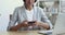 Professional businesswoman using smartphone texting message in office, closeup